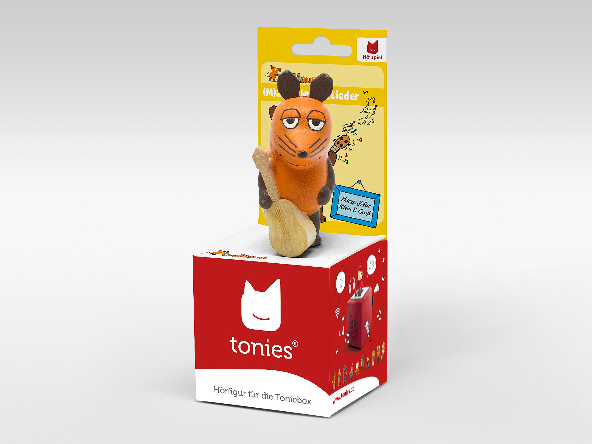 Eine Spielzeug-Mausfigur mit Gitarre, auf einer roten Box mit dem Schriftzug 'tonies'.