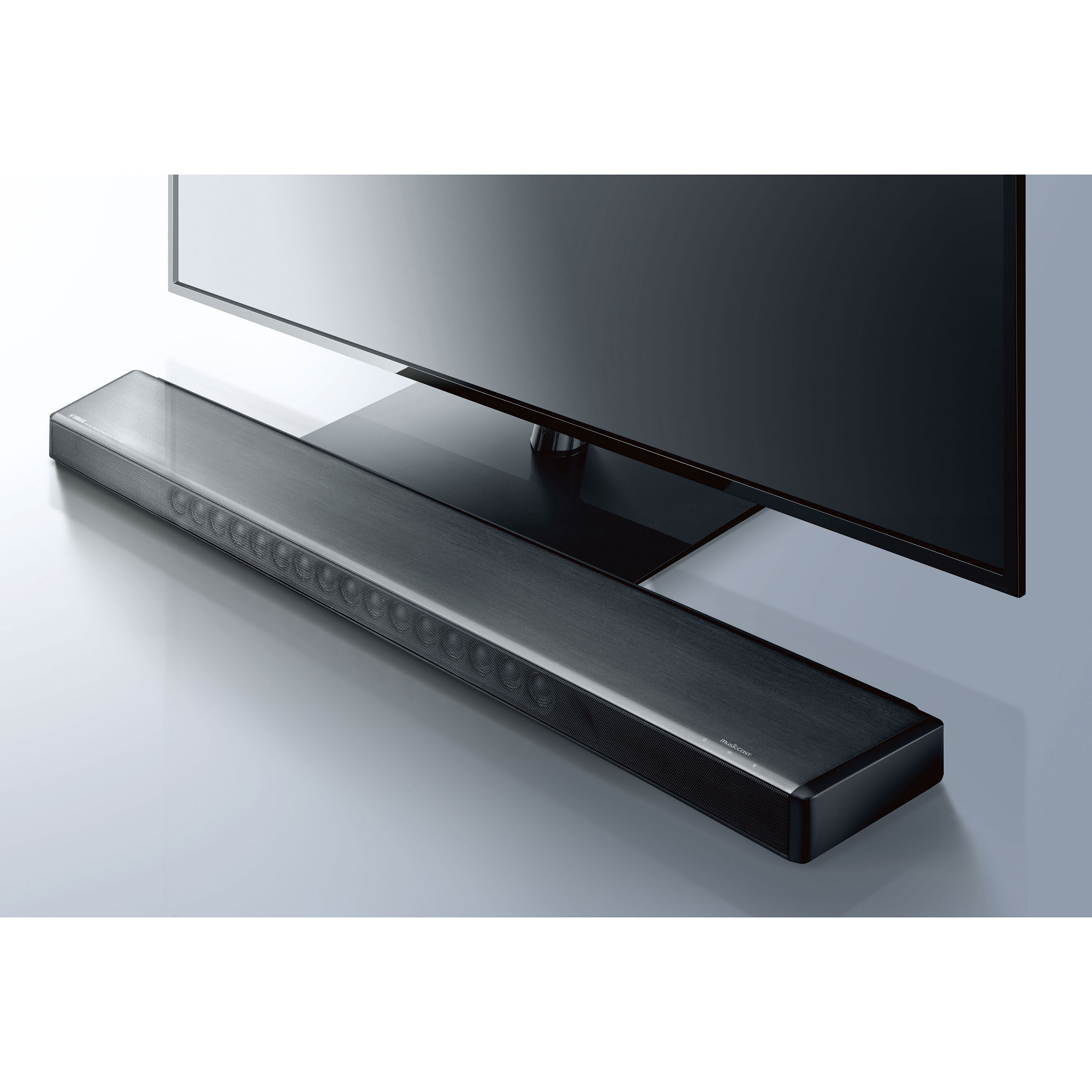 Eine schwarze Soundbar vor einem schwarzen Fernseher platziert.