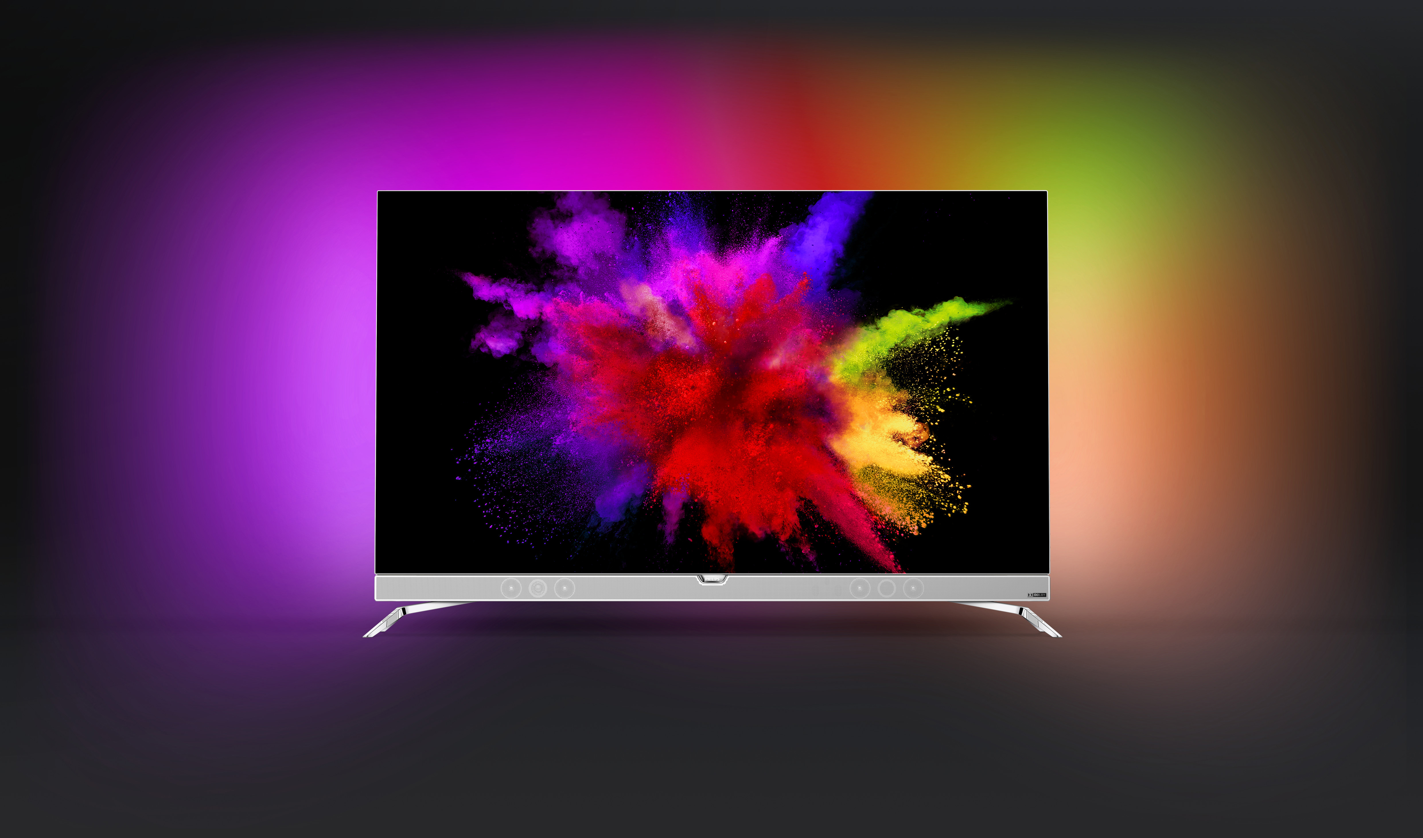 Ein Fernseher, der eine farbenfrohe Explosion von Farbe auf schwarzem Hintergrund zeigt.