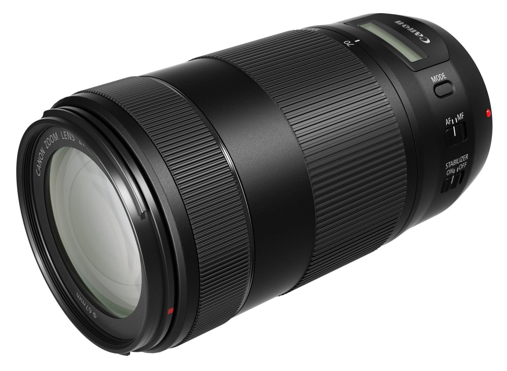 Schwarzes Canon Zoomobjektiv. Zylindrische Form. Hat Steuerringe, Modus- und Stabilisatortasten. Canon-Logo.