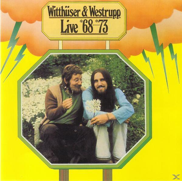 Albumcover mit zwei Männern, einer hält Blumen, in einem grün umrandeten Foto, mit Text 'Live '68-'73'.