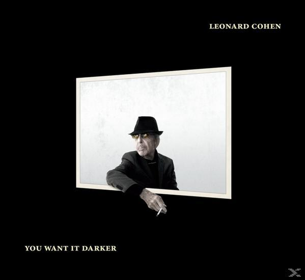 Leonard Cohen in schwarzem Anzug und Hut, raucht eine Zigarette, in einem Fensterrahmen, schwarzer Hintergrund.