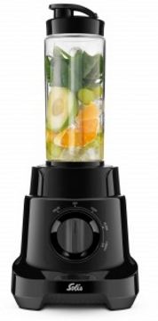 Un mixeur noir avec un récipient transparent contenant des fruits et des légumes-feuilles.