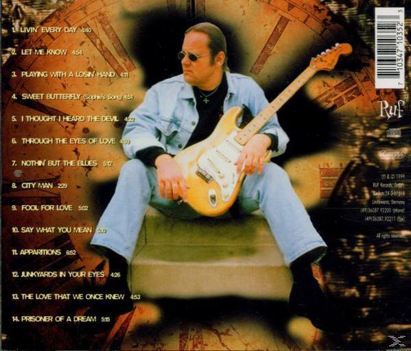 Album-Rückseite mit einem Mann, der eine Gitarre hält, und Trackliste.
