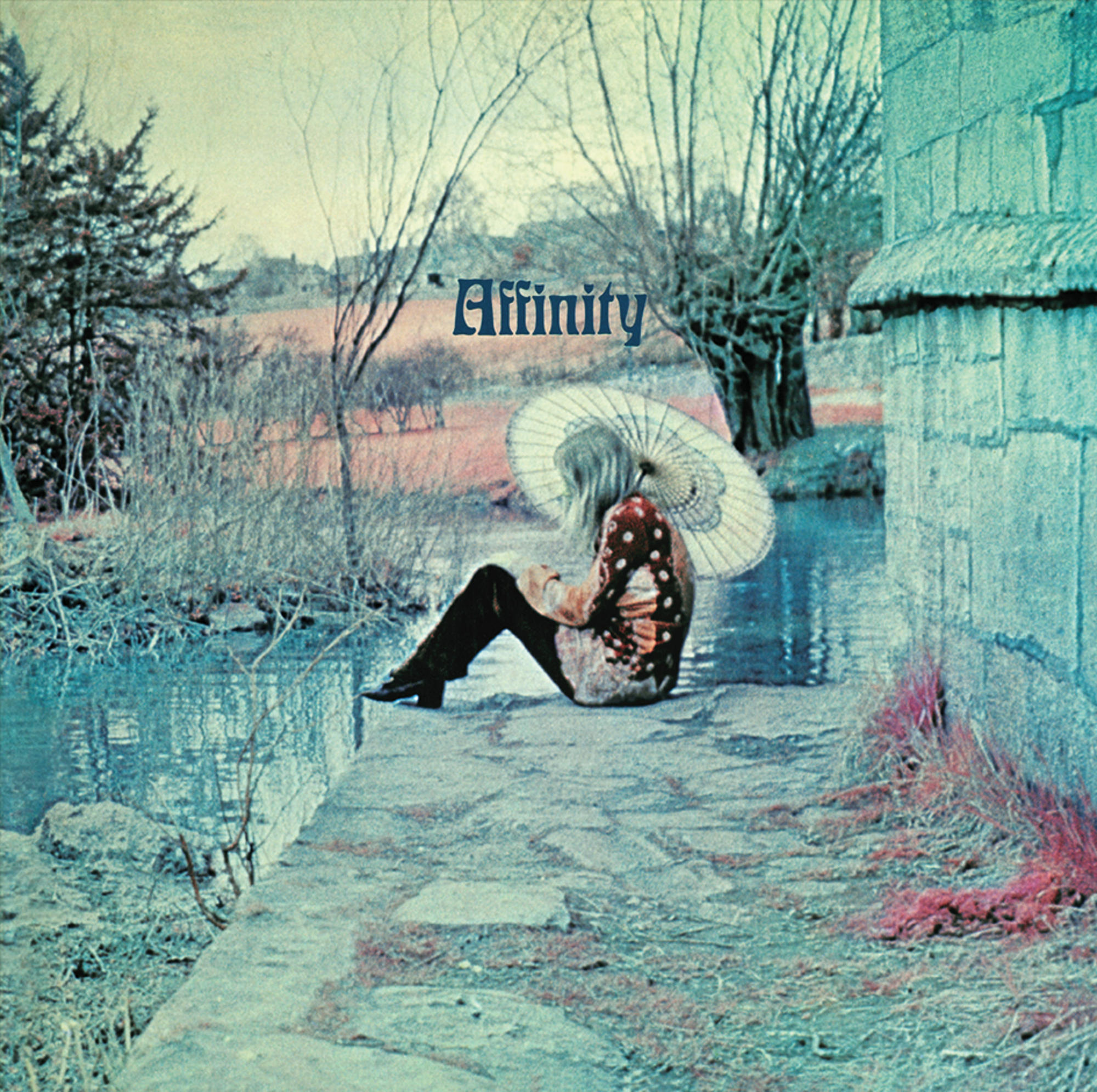 Albumcover, Frau mit Sonnenschirm am Wasser, Bäume und Gebäude im Hintergrund.