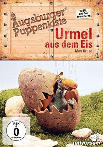 DVD-Cover: Urmel aus dem Eis. Ein Dinosaurier schlüpft aus einem Ei auf Gras.