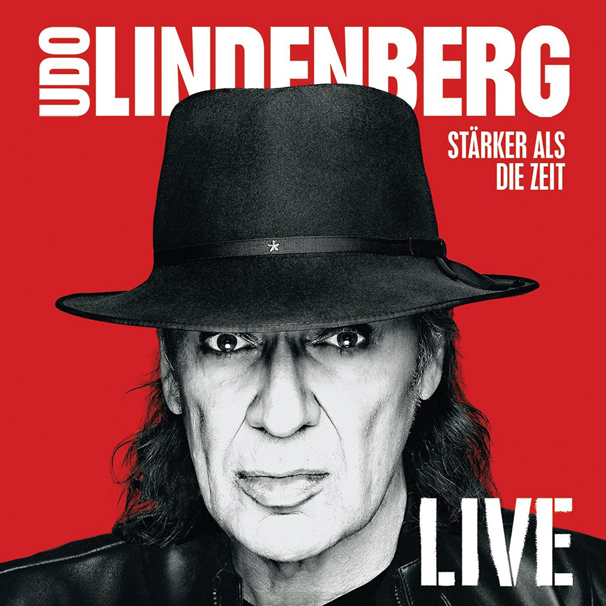 Udo Lindenberg Albumcover. Ein Mann mit schwarzem Hut auf rotem Hintergrund.