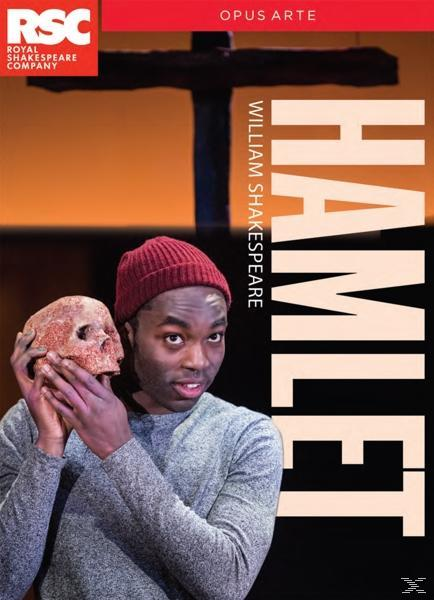 Mann hält Schädel, 'Hamlet'-Cover, dunkler Hintergrund.