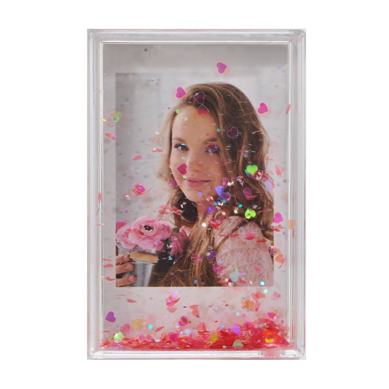 Foto in einem transparenten Rahmen mit schwebenden Herzen. Eine Frau mit Blumen lächelt.