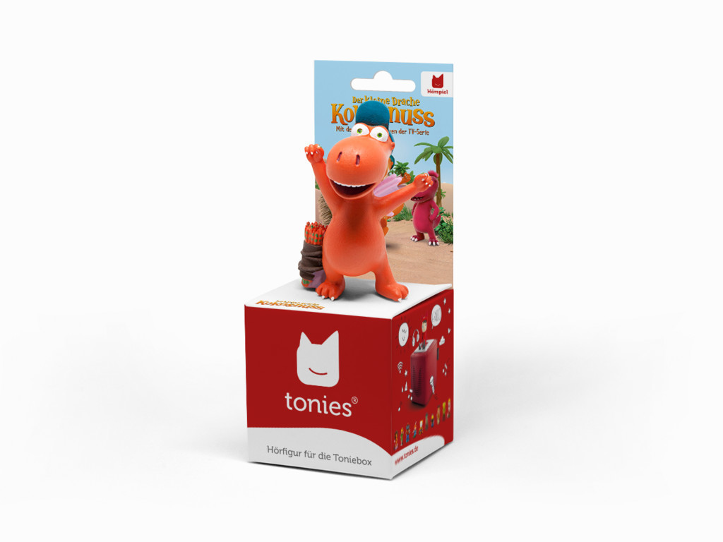 Eine Spielfigur eines roten Dinosauriers auf einem roten Würfel mit Text und einer Box.