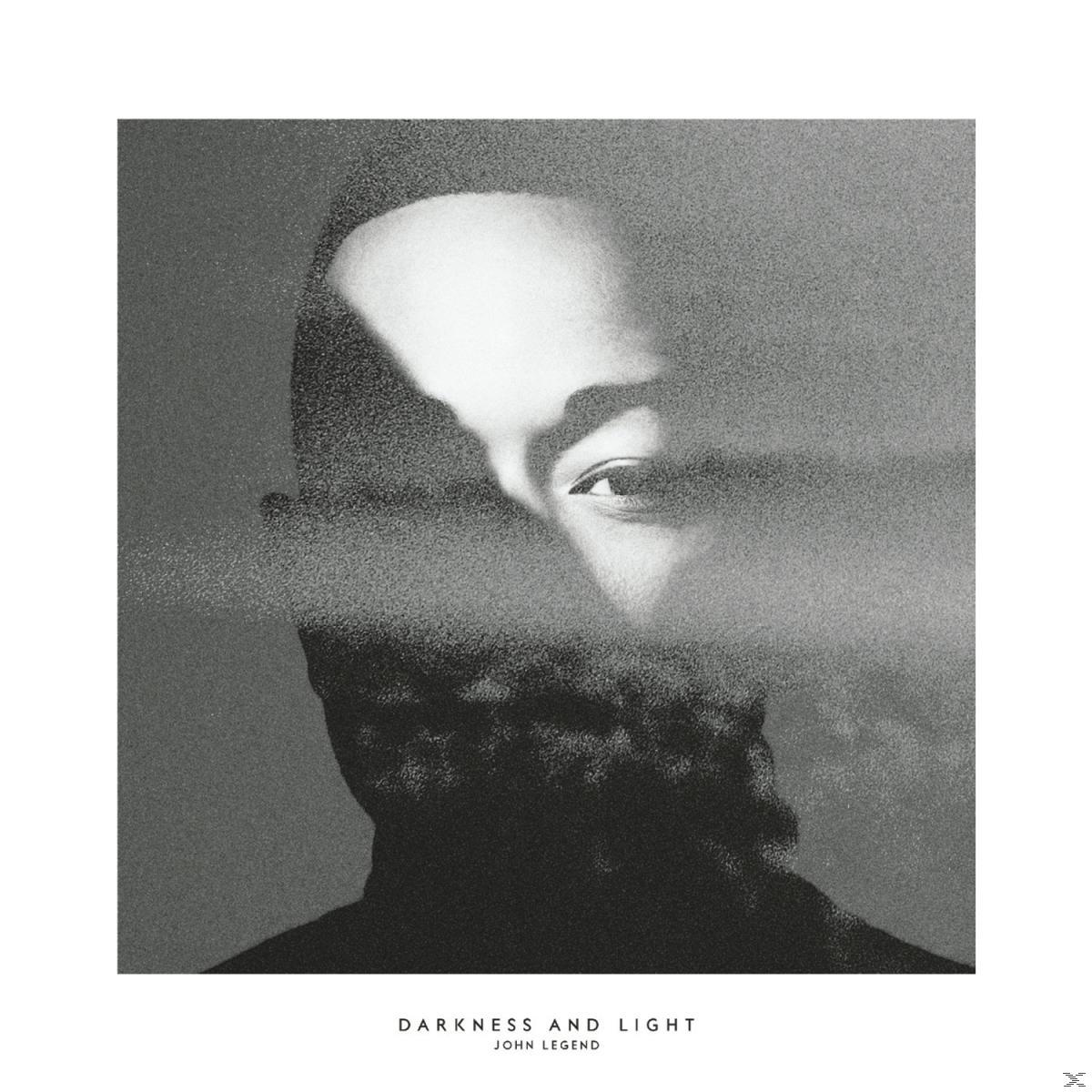 Ein Schwarz-Weiß-Porträt eines Mannes, teilweise durch einen körnigen Effekt verdeckt. Titel: Darkness and Light, John Legend.