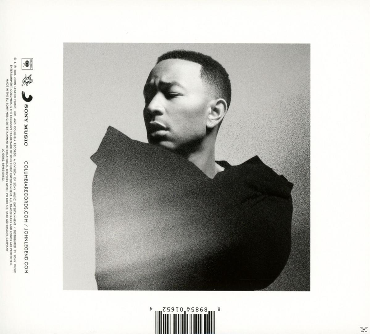Schwarz-Weiß-Porträt von John Legend. Er trägt ein schwarzes Hemd und blickt nach links. Hintergrund ist weiß. Album-Informationen links.