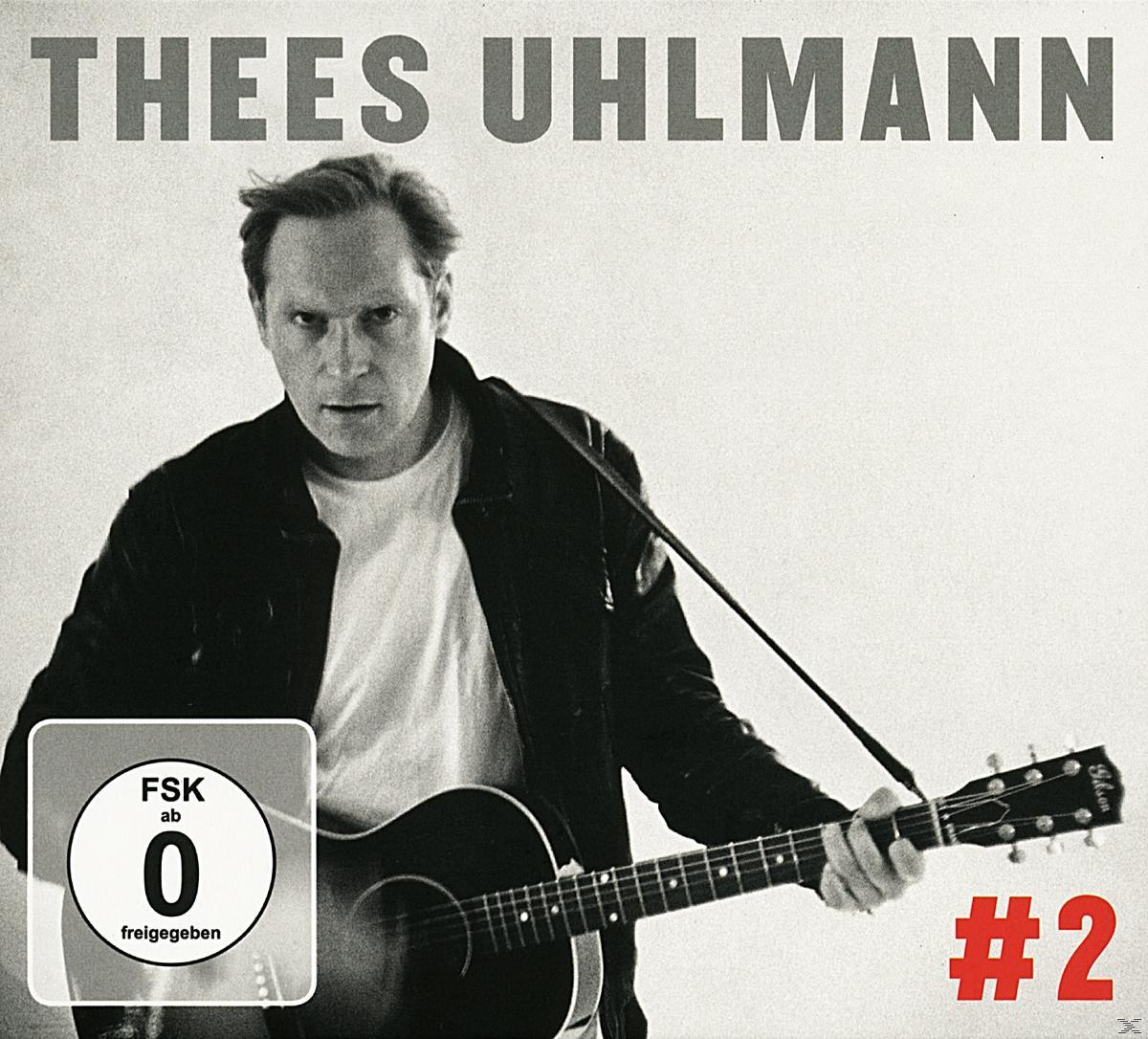 Albumcover mit einem Mann, der eine Gitarre hält, mit schwarzer Jacke und weißem Hintergrund.