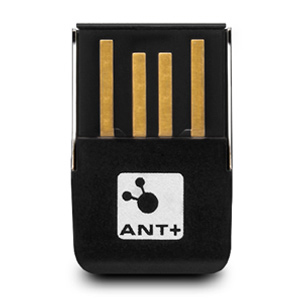 Kleines, schwarzes USB-Gerät mit goldenen Anschlüssen. Weißer Hintergrund. Das Gerät hat das ANT+-Logo.