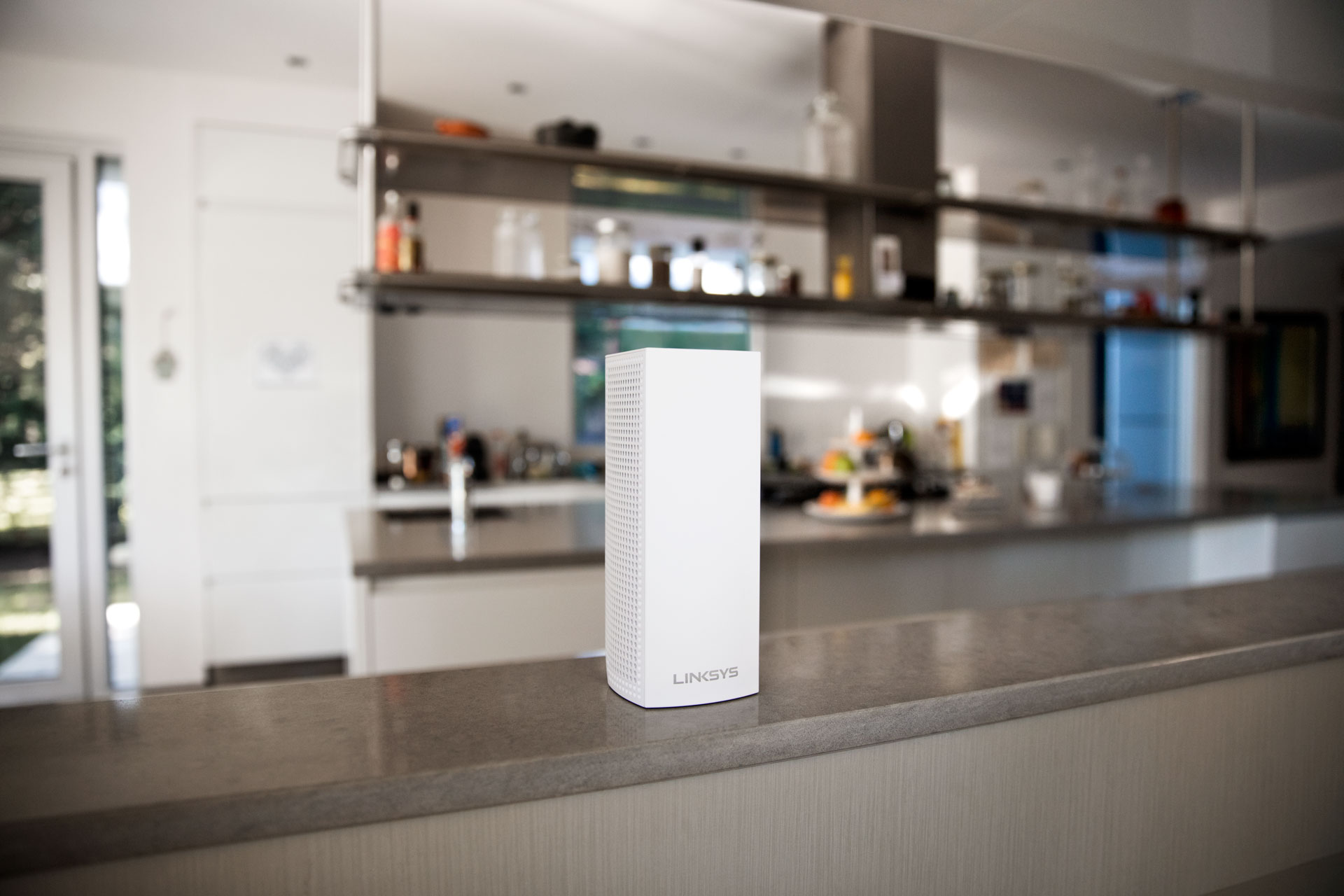 White rectangular router on a countertop, kitchen in the blurry background.