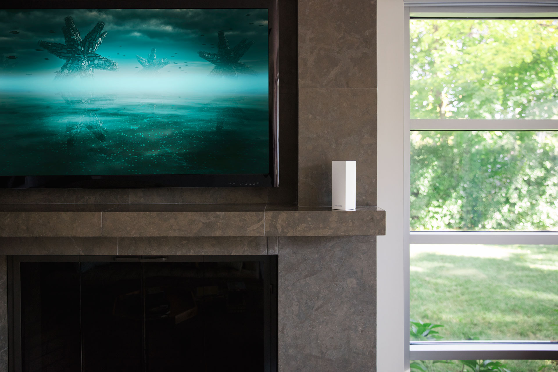 Living room with a TV displaying a futuristic scene, a fireplace, and a window.