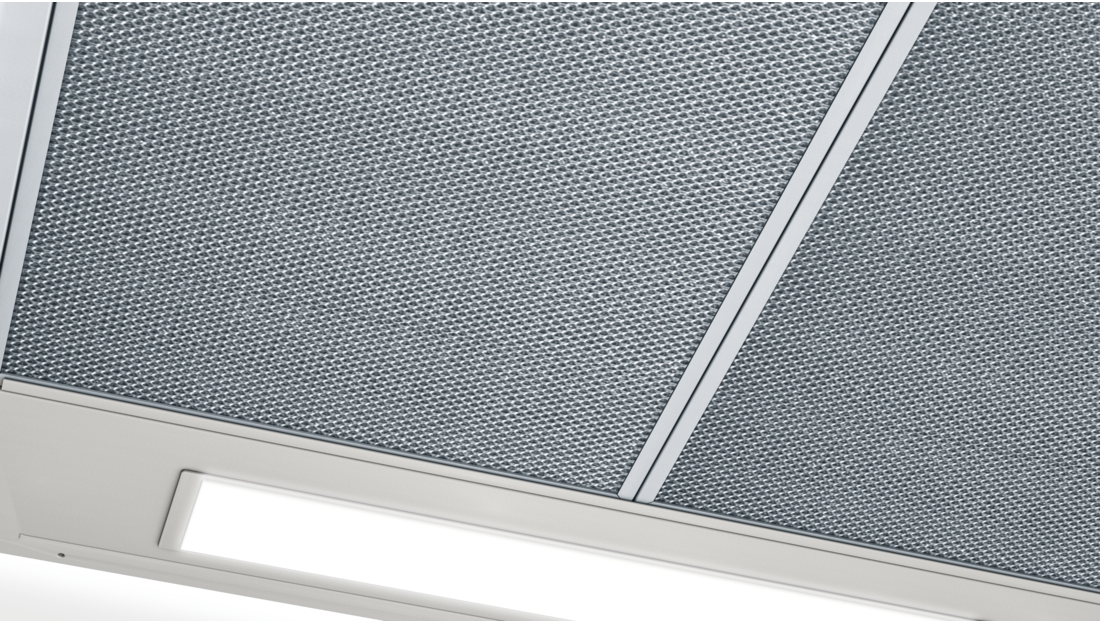 Close-up view of a metal ventilation grid and a white light fixture.