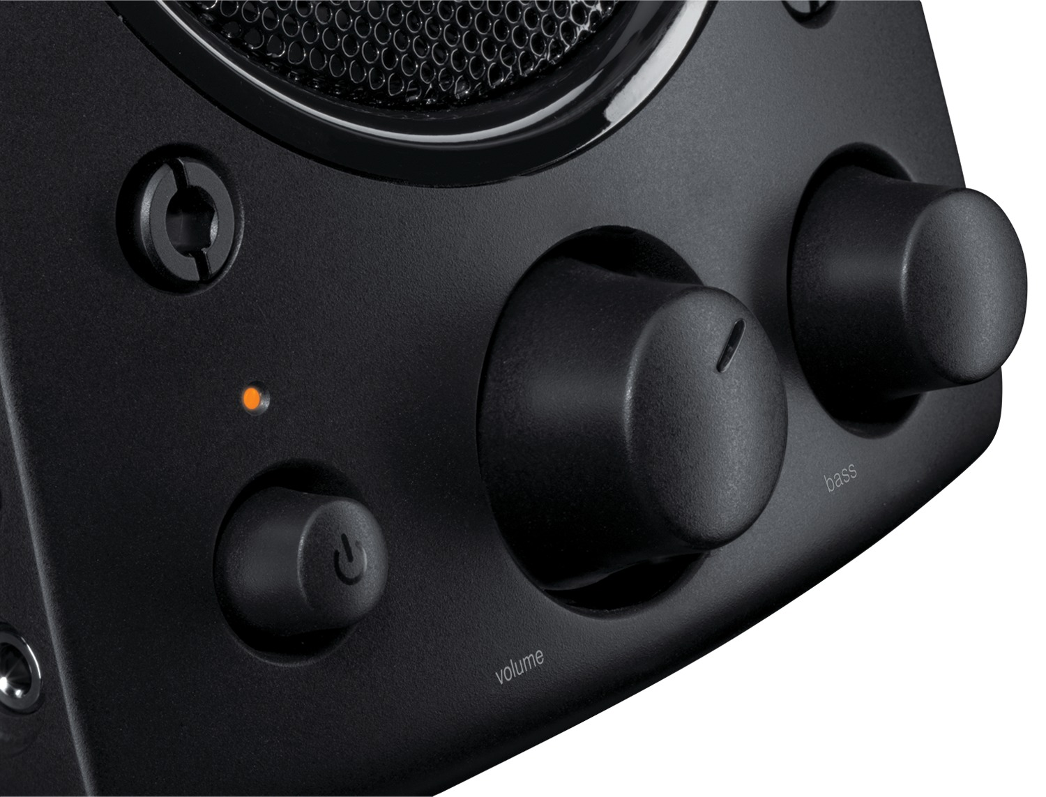 Close-up of a black speaker control panel with volume, bass knobs, power button, and a status light.