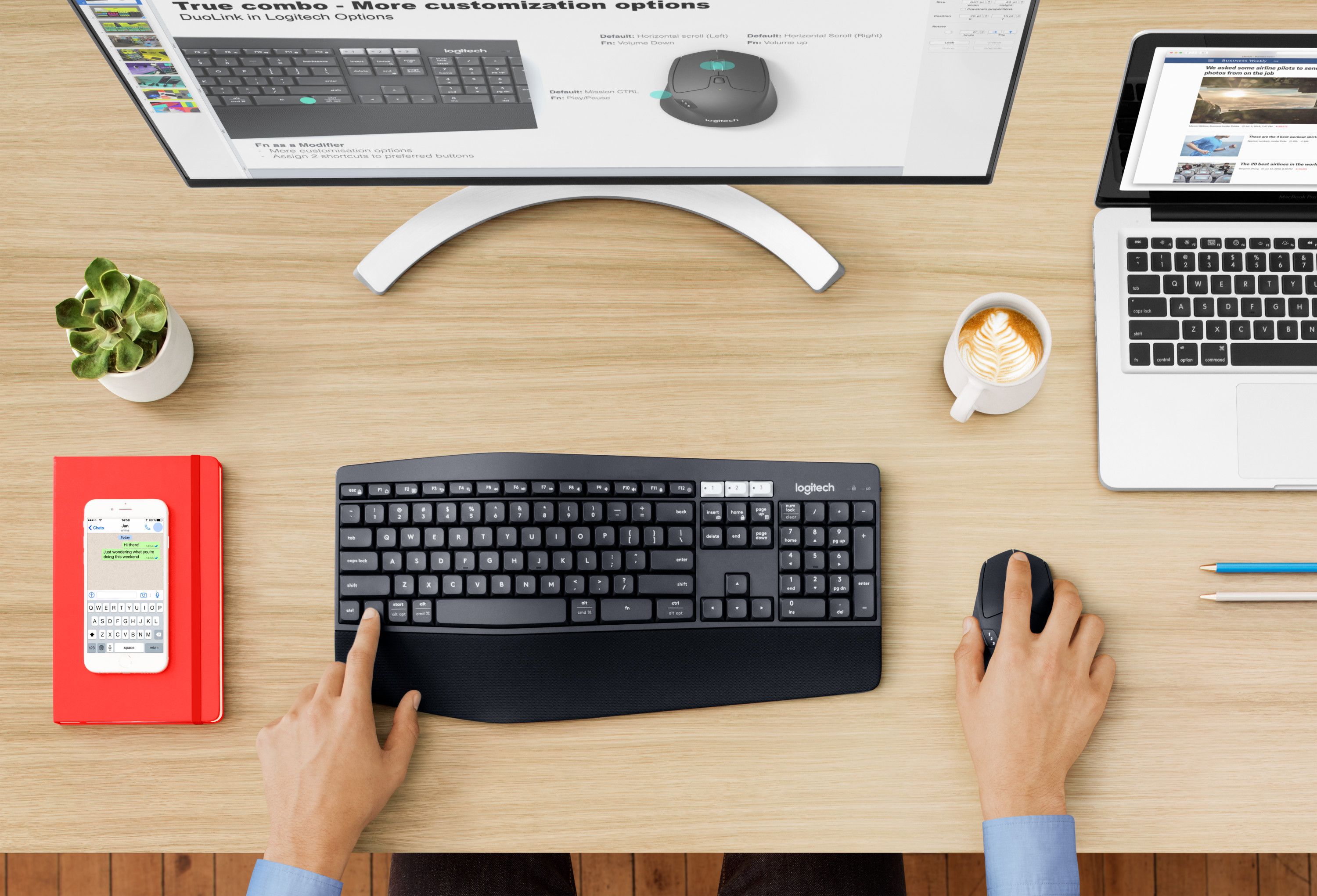 Overhead view of a desk with a keyboard, mouse, monitor, laptop, and other office items.