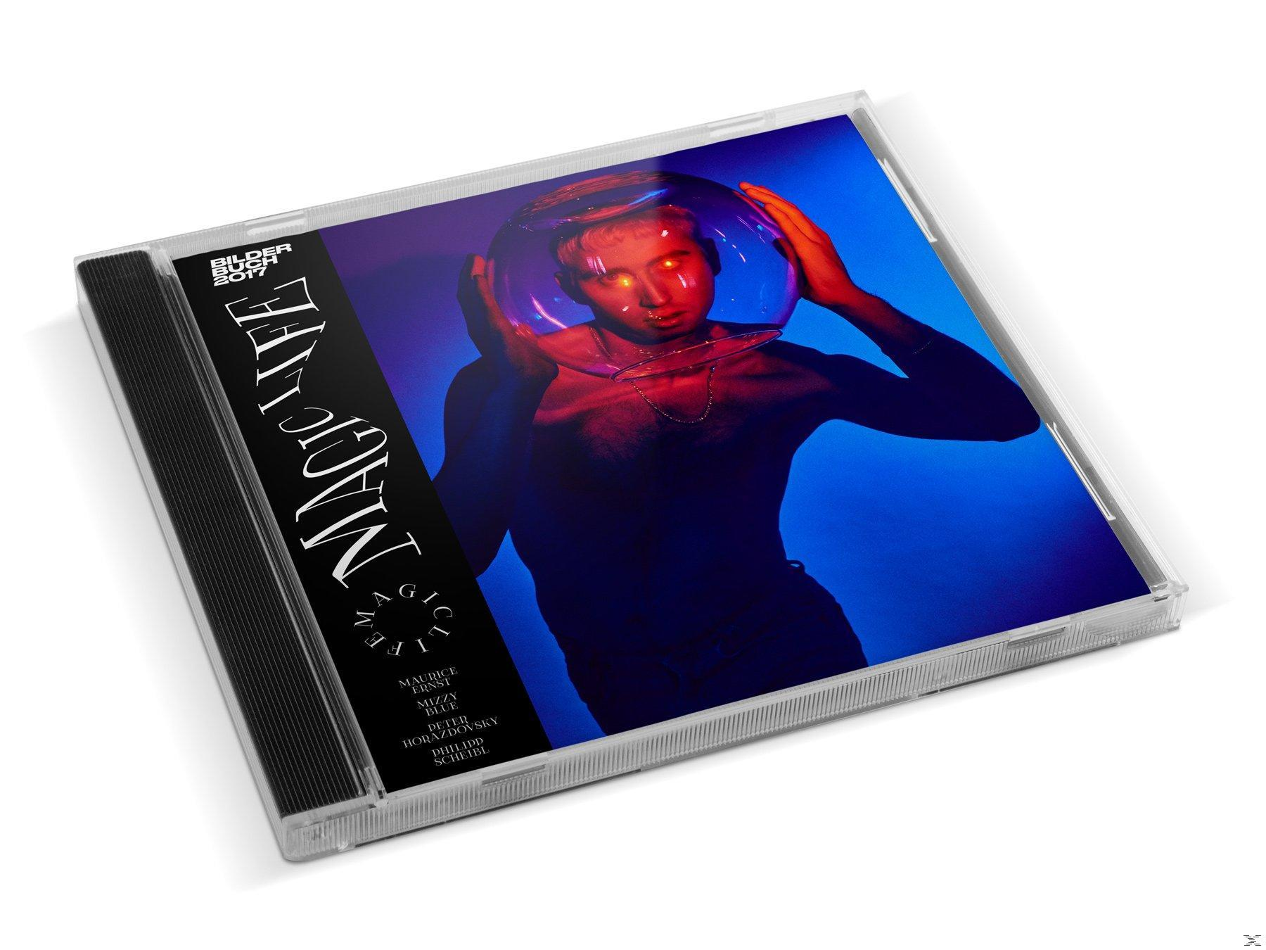 CD-Hülle mit einer Person in einem Glaskopf. Albumtitel ist Magic Life.