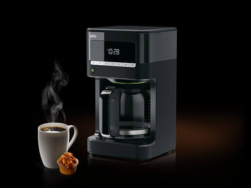 A black coffee machine with a digital clock, a cup, and a muffin on a dark background.