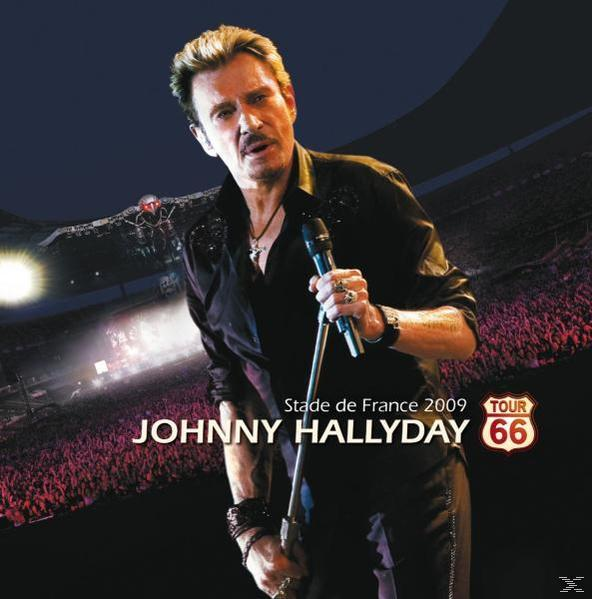 Johnny Hallyday sur scène avec un micro et une foule au Stade de France.