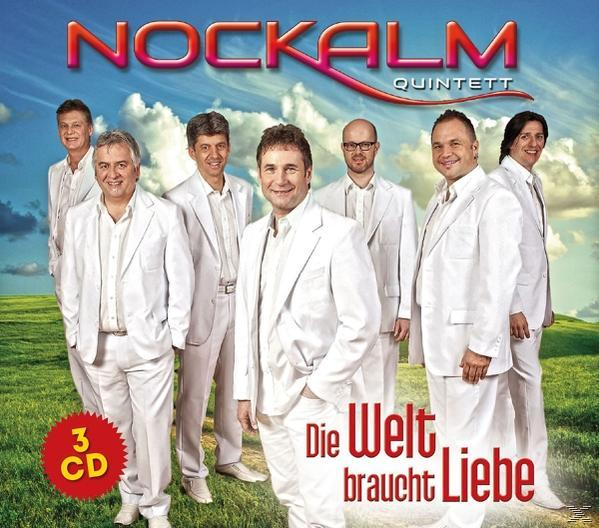 Albumcover: Eine Gruppe Männer in weißen Anzügen, Titel 'Die Welt braucht Liebe' und der Bandname.