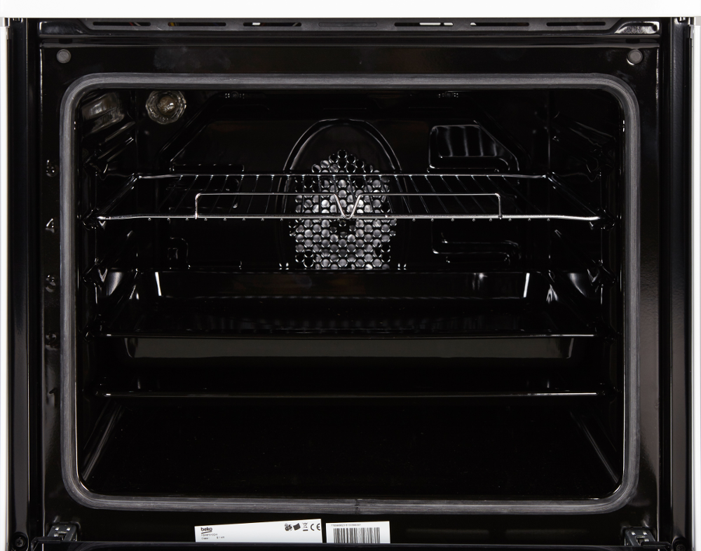 Open oven interior. Black, with metal racks and a fan. The inside is dark and clean.