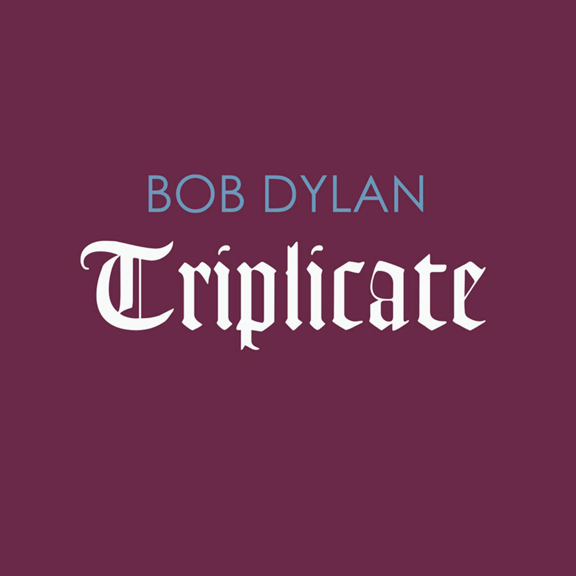 Albumcover mit dem Titel 'Triplicate' über einem weinroten Hintergrund, darüber 'Bob Dylan'.