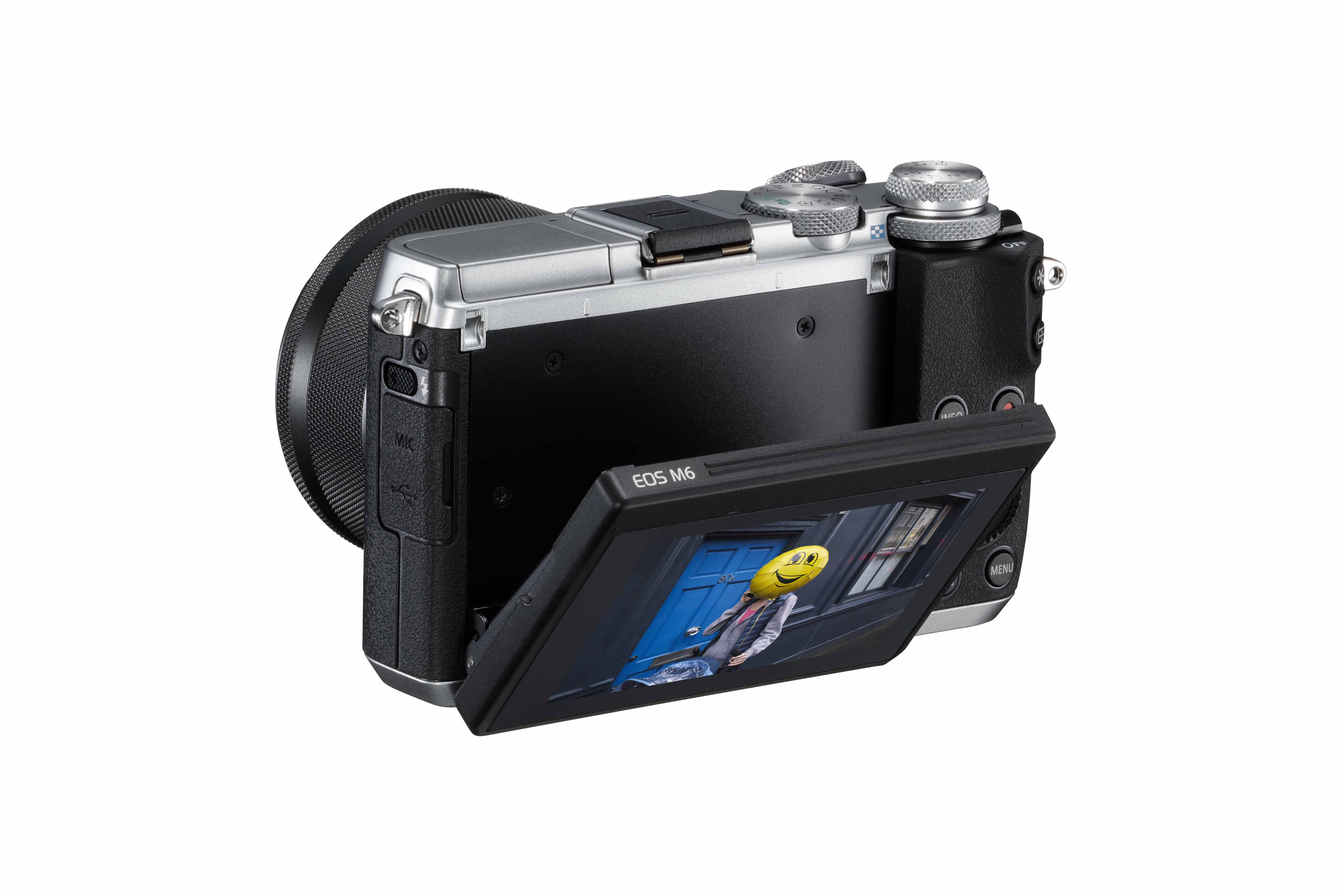 Een camera met een scherm met een smiley. De camera is zwart en zilver.