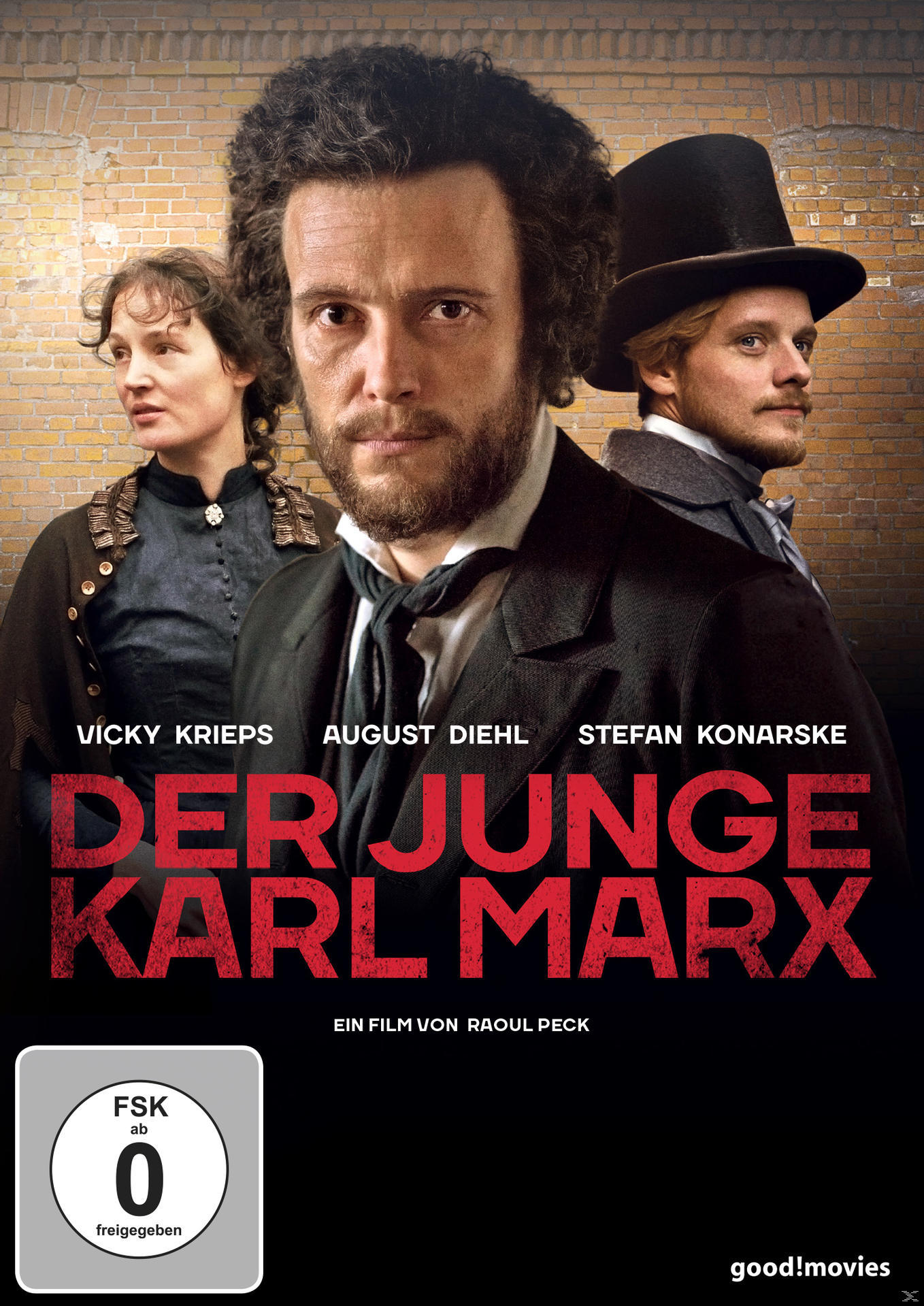 Filmplakat: Der Junge Karl Marx mit Schauspielernamen. Titel in Rot, Gesichter der Schauspieler, Backsteinmauer.