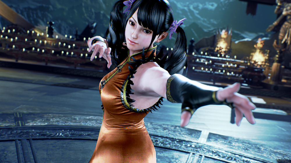 Personnage féminin de Tekken avec des cheveux noirs et une robe orange. Elle pose.