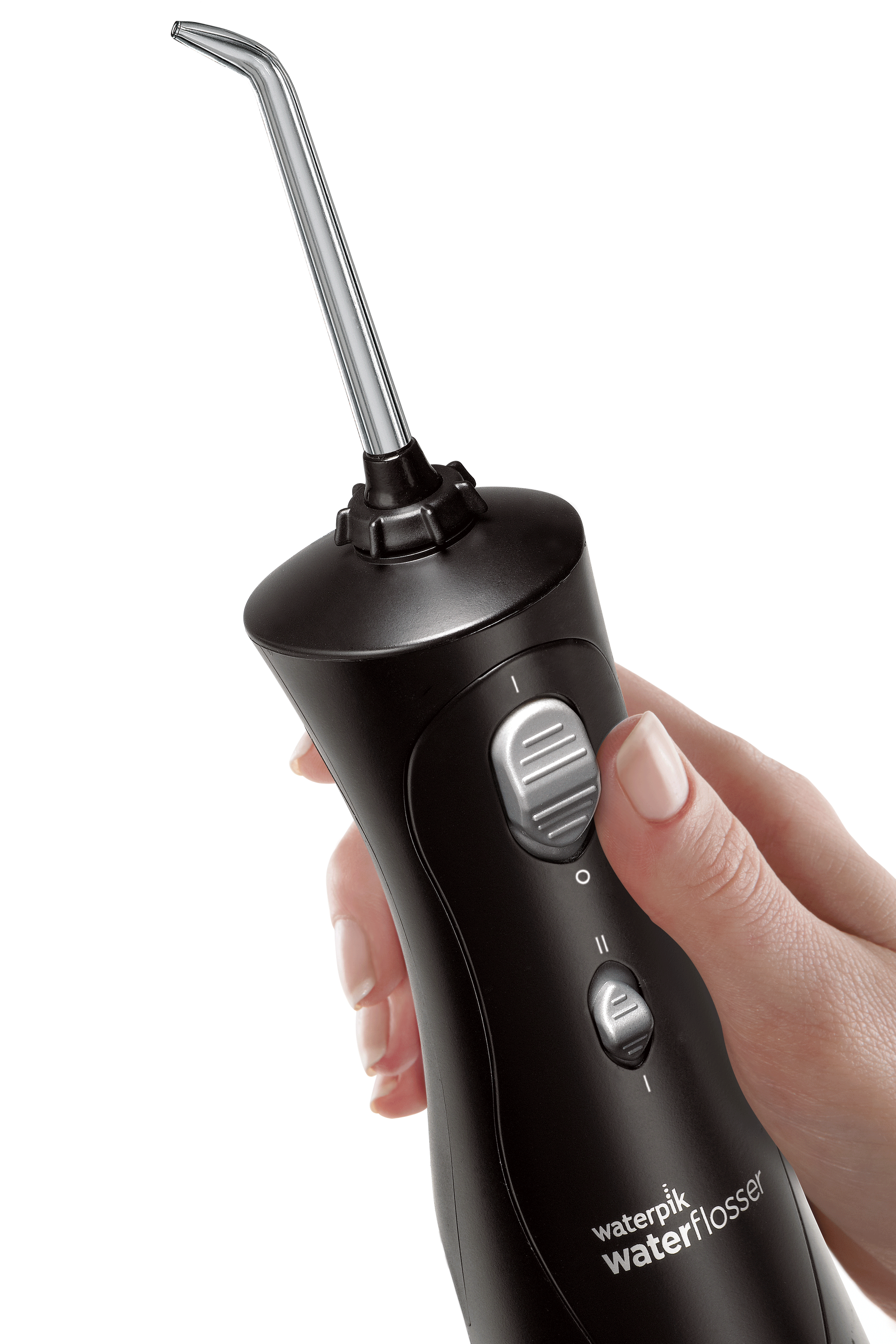 Black water flosser with a silver tip. A hand is holding the flosser.