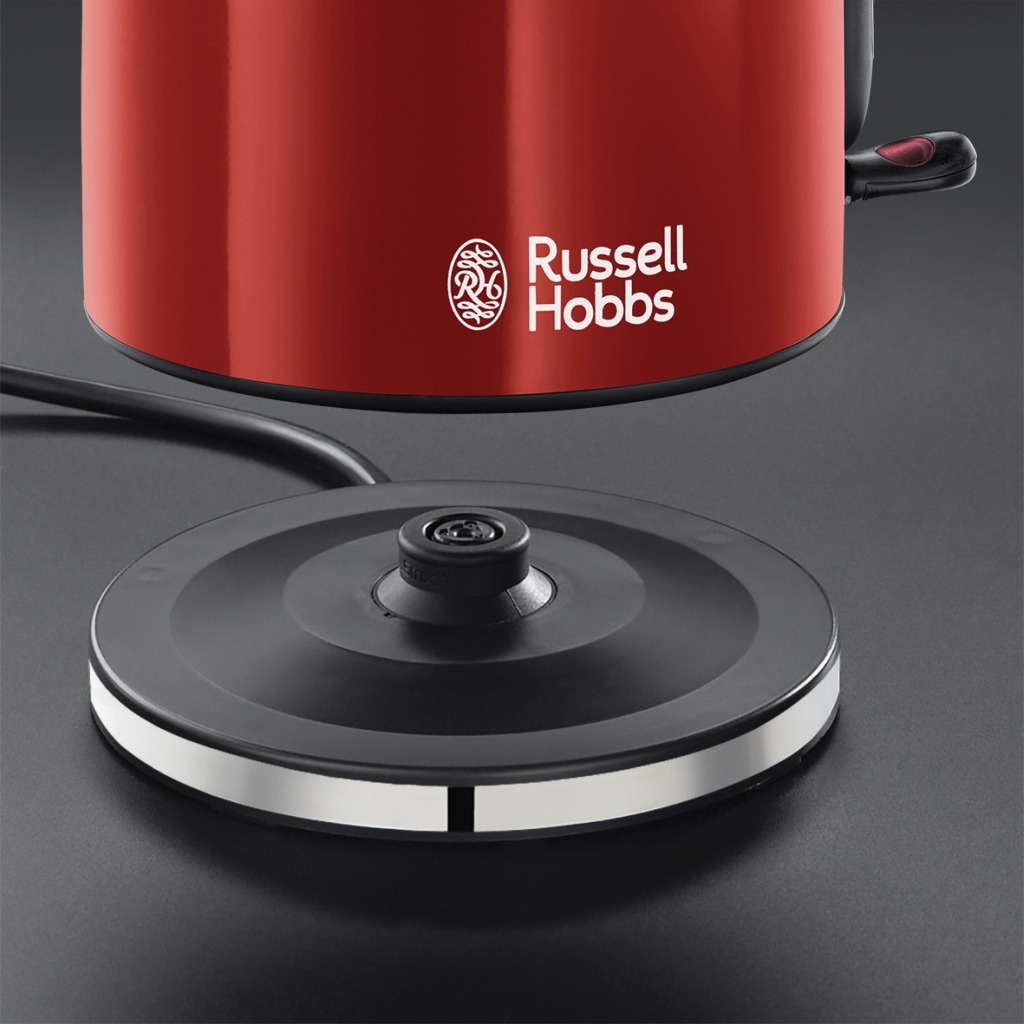 A red Russell Hobbs electric kettle on a black base, with the brand logo visible.