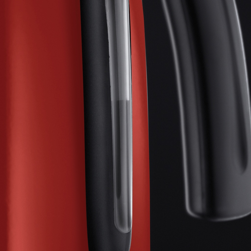 A close-up of a red and black object with a transparent tube, possibly a part of a machine.