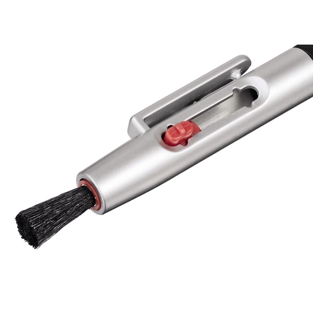 Close-up of a silver lens cleaning brush with a black brush head and a red accent.