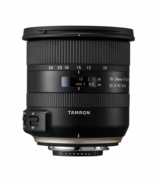Black camera lens with white text, focus and distance markings, on white.
