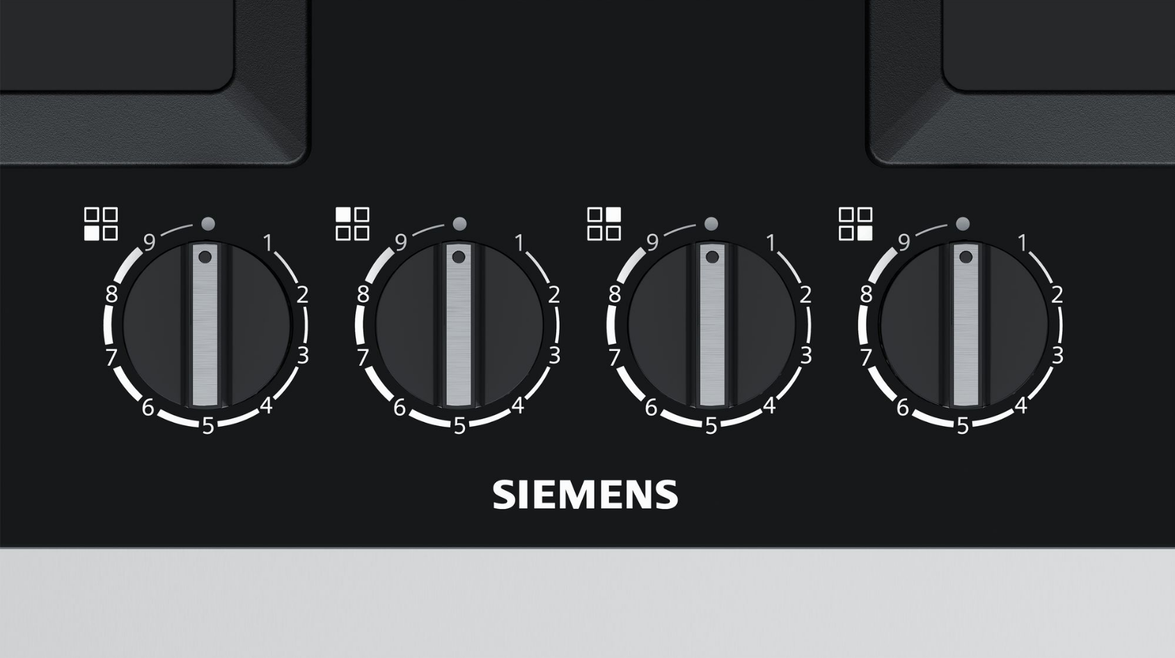 Black oven control panel with four knobs, labeled 1-9.