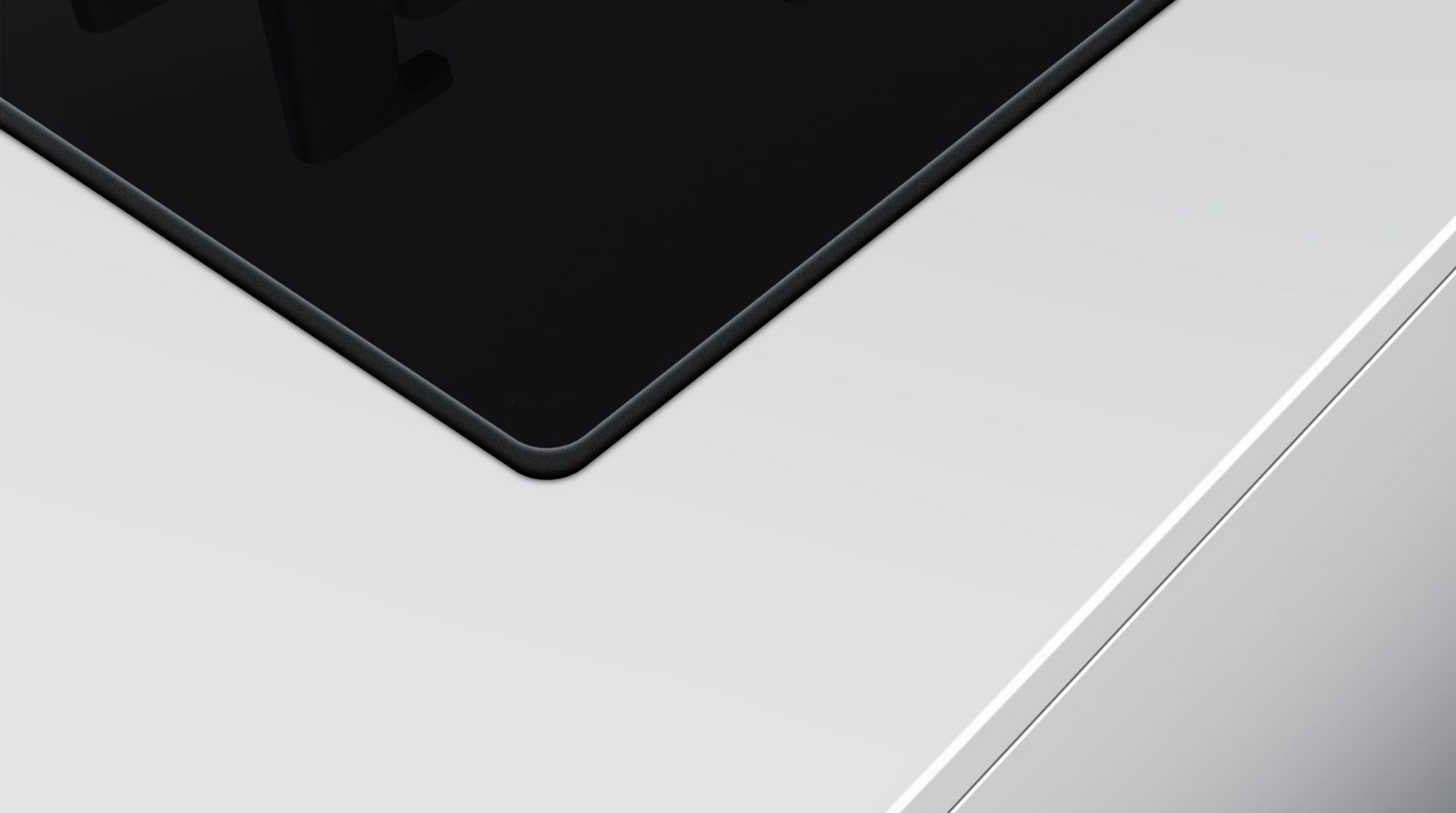 Close-up of a black stovetop on a white countertop.