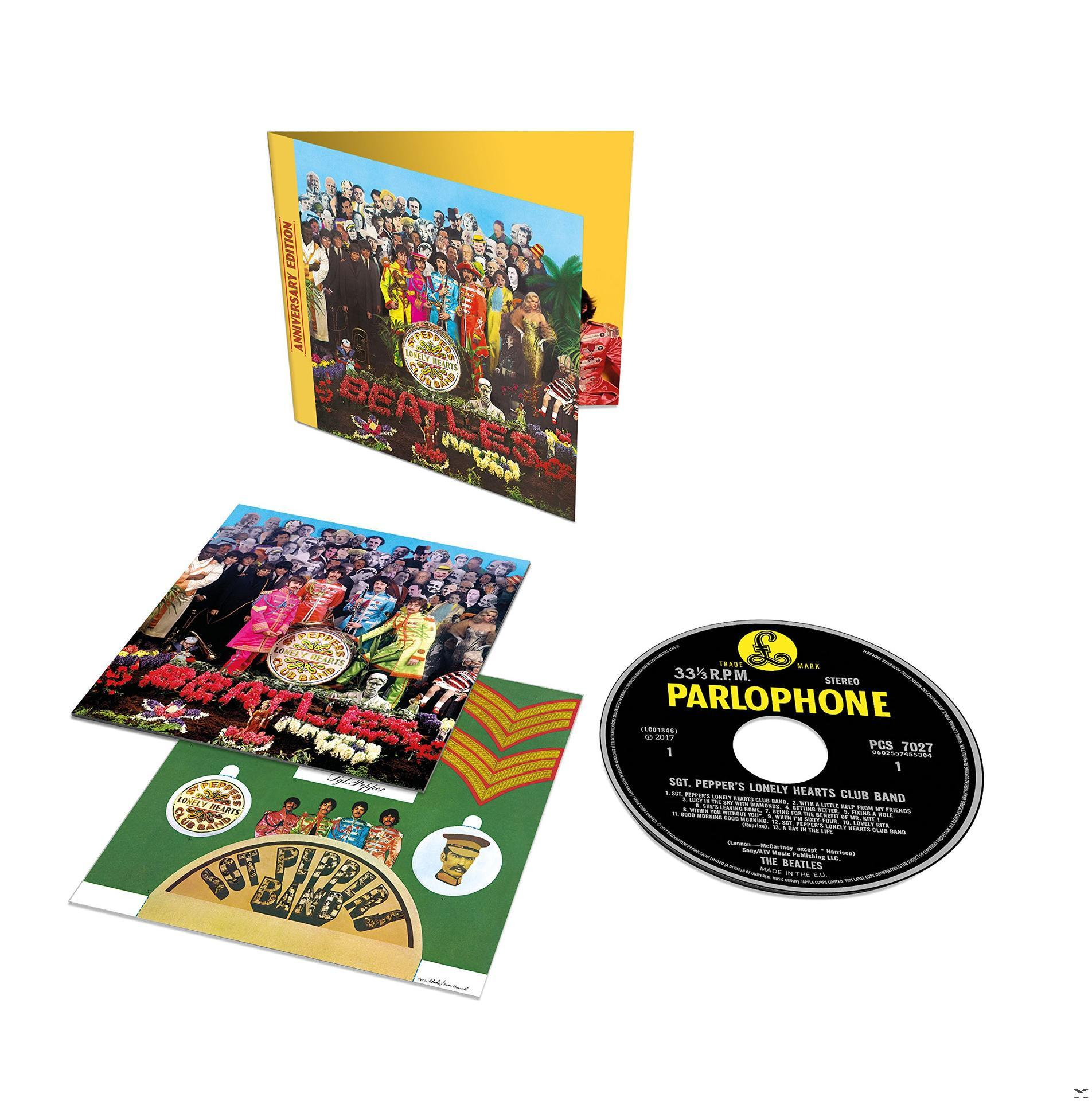 Beatles-Albumcover. Gelbes Cover mit Foto der Bandmitglieder und verschiedenen Einsätzen.