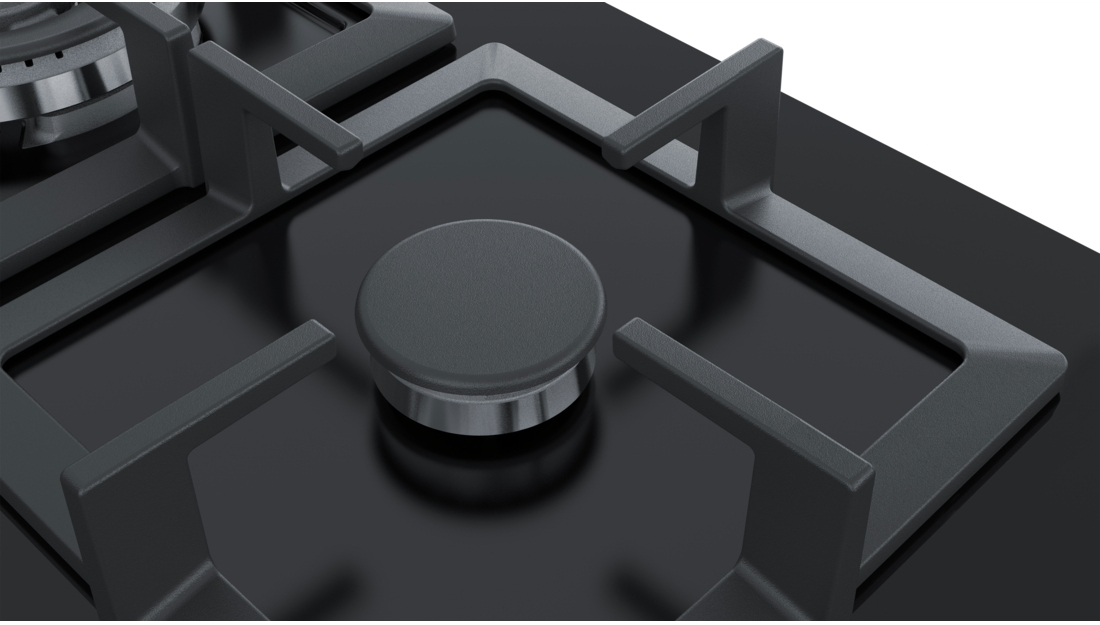 Black gas stove cooktop with four burner grates.