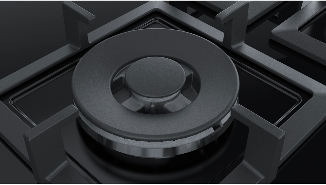 A close-up of a black gas burner. It's a circular design with a central knob and vents.