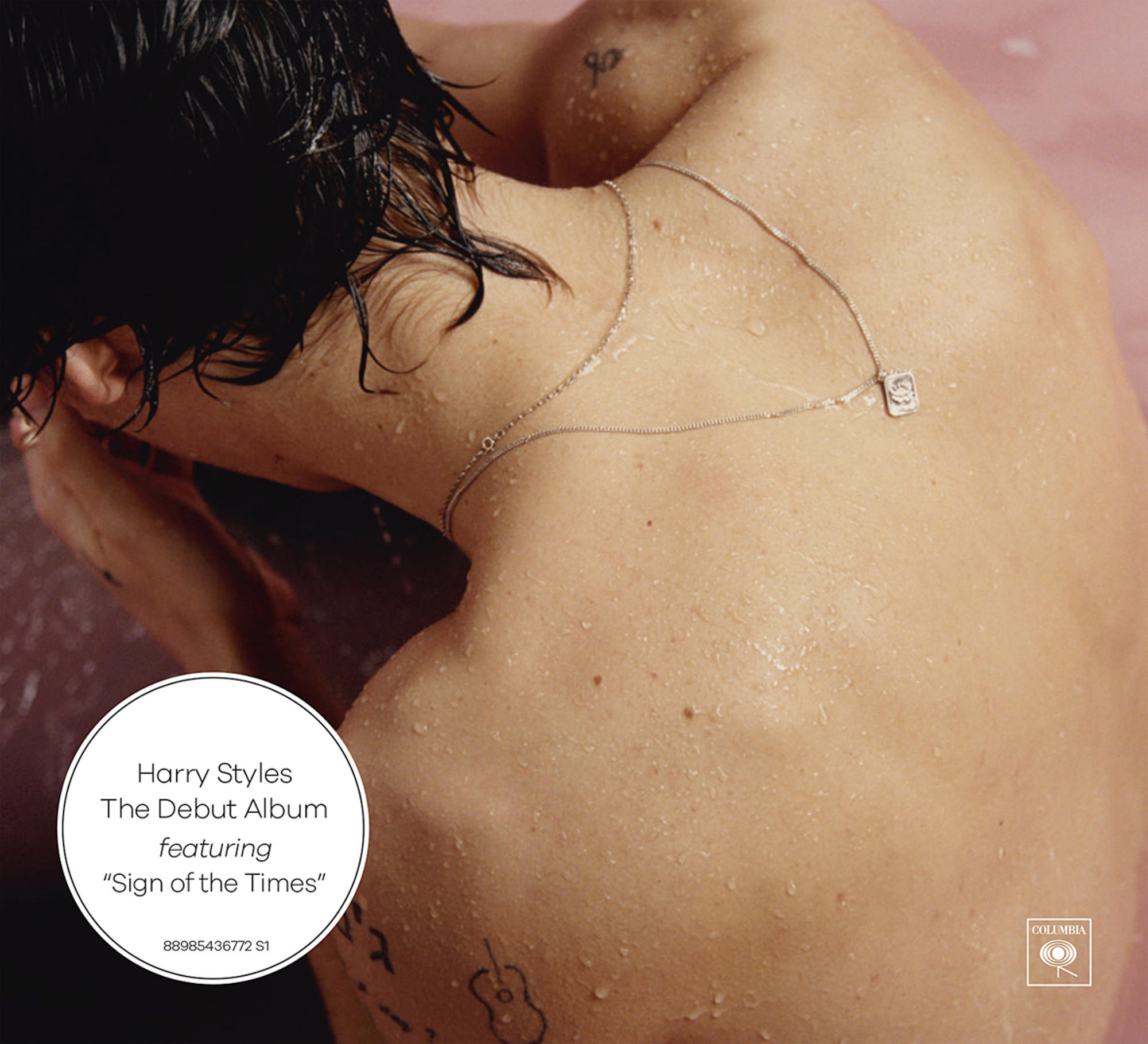 A man with tattoos, shirtless, with a silver necklace. Pink background. Text: Harry Styles. The Debut Album.