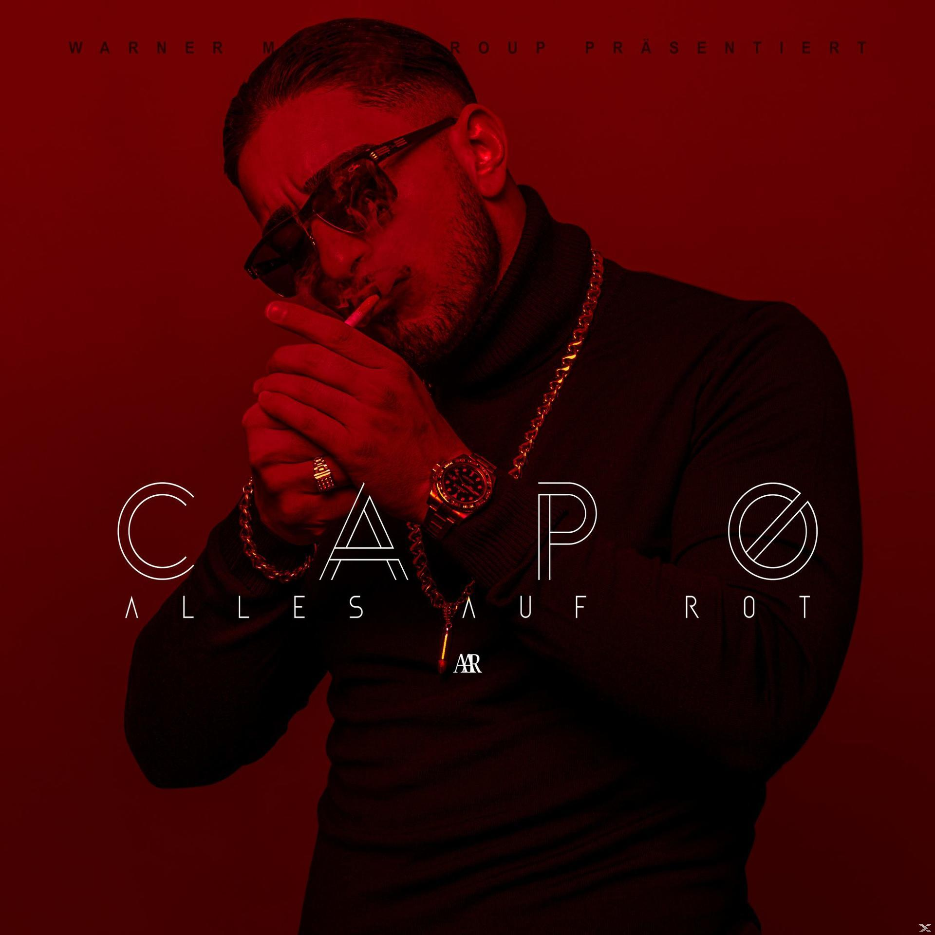 Albumcover. Mann mit Sonnenbrille raucht, trägt Goldkette. Roter Hintergrund, weißer Text: CAPO.