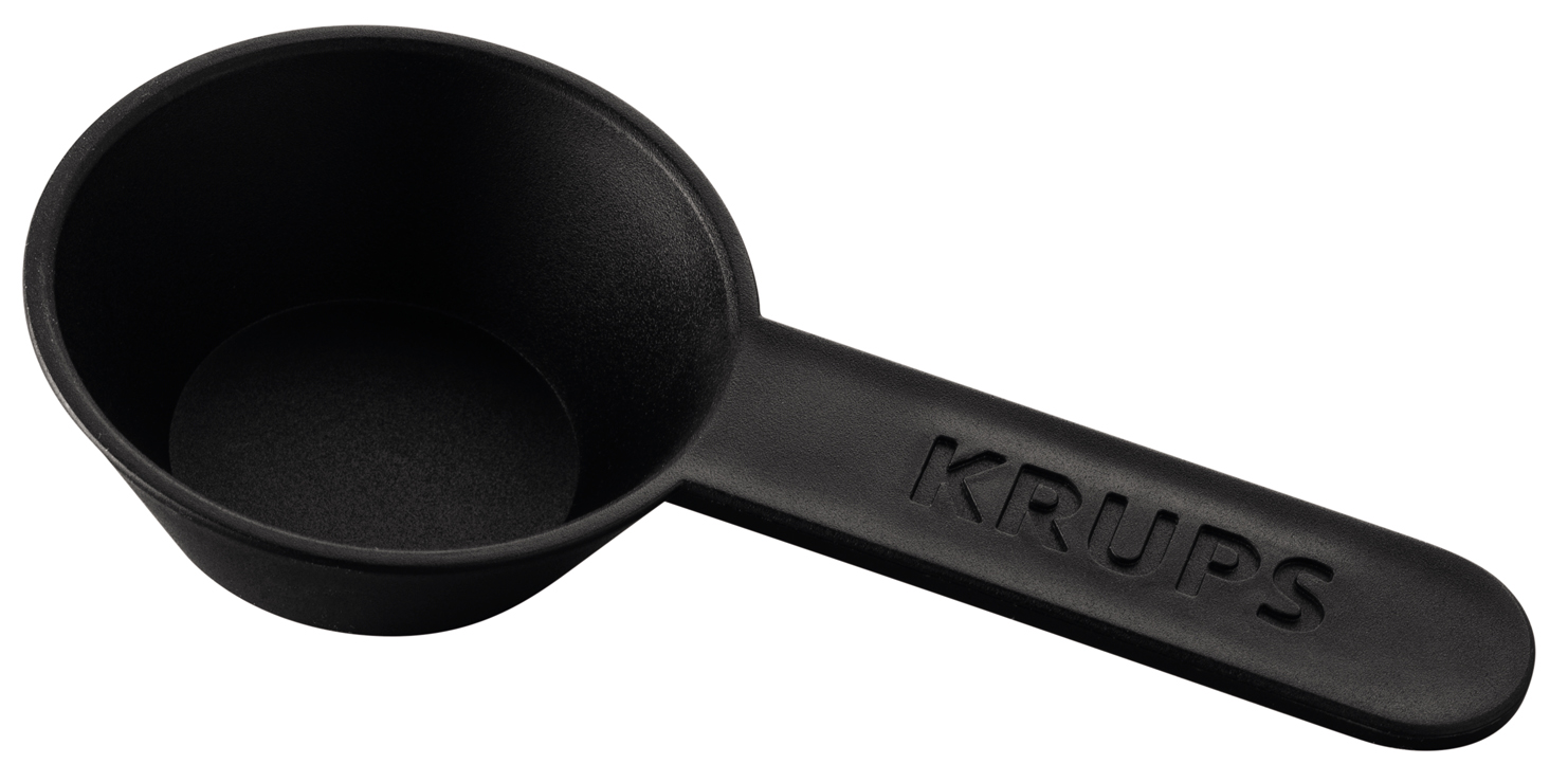 Black Krups measuring spoon. The spoon is in focus, showing the 'KRUPS' logo.