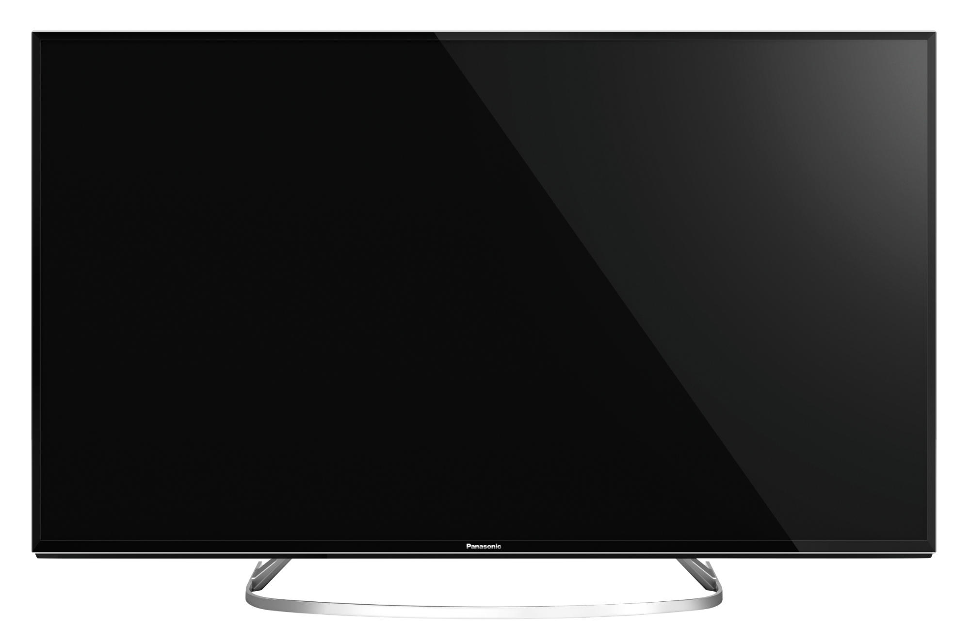 Televisor de pantalla plana grande. La pantalla es negra, con un soporte plateado. Fondo liso.