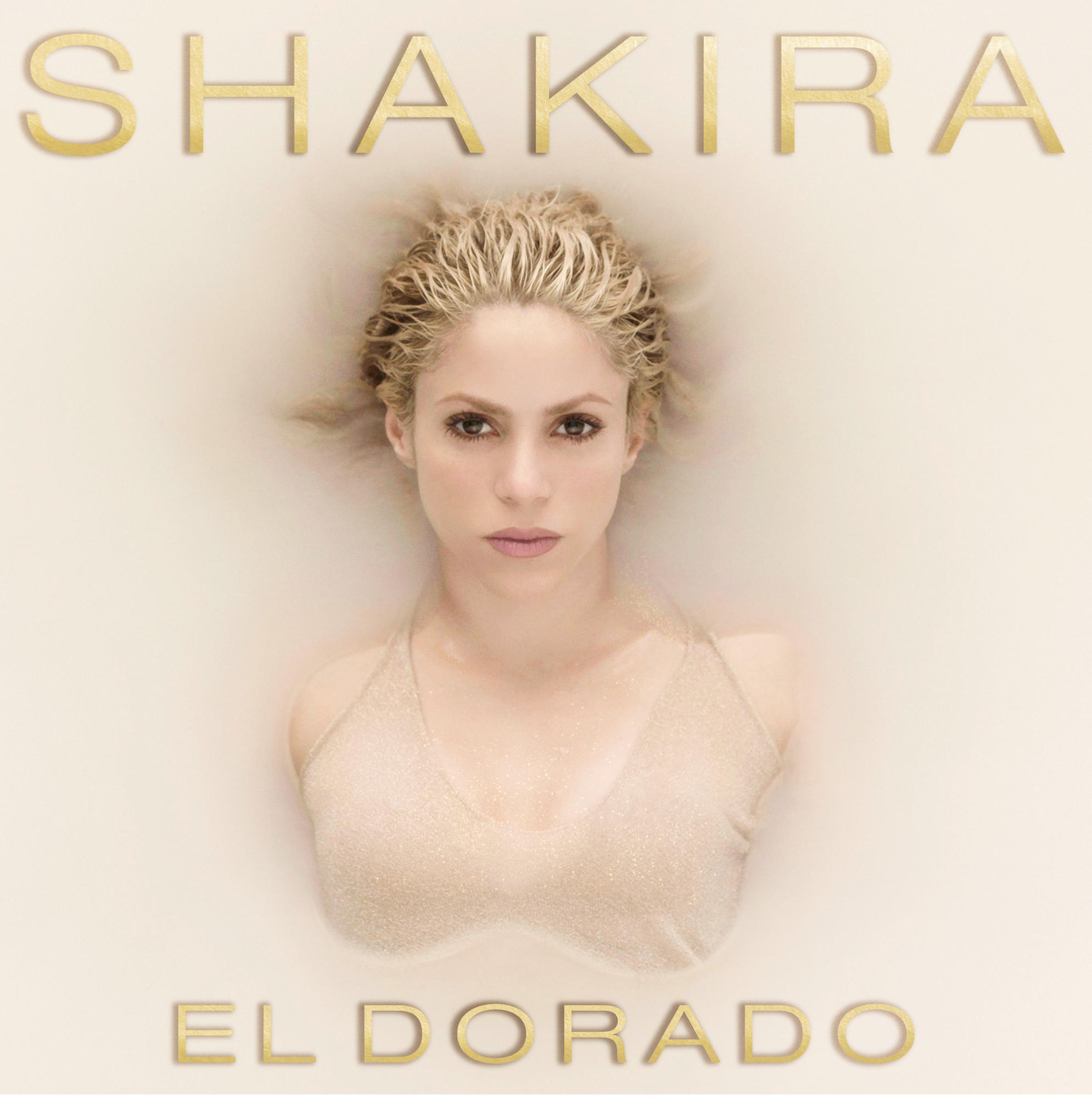 Shakiras Albumcover. Blondes Haar, das aus Flüssigkeit auftaucht, goldfarbene Schrift: SHAKIRA EL DORADO.