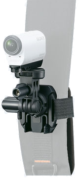 White Sony action camera attached to a black mount and strap. The mount is on a gray surface, likely a limb.