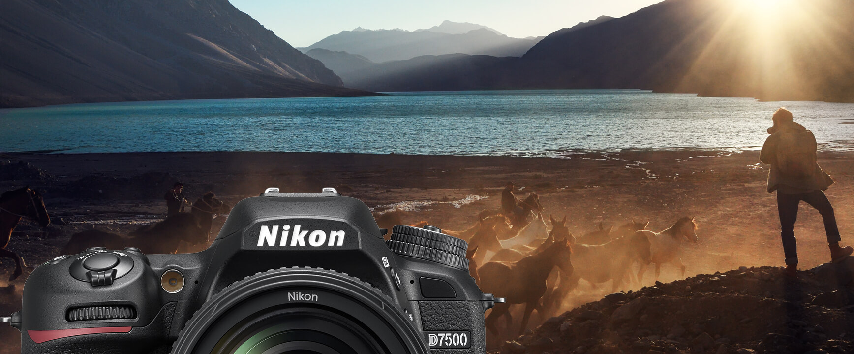 Nikon kamera előtérben, lovak futnak a háttérben, hegyek és tó.