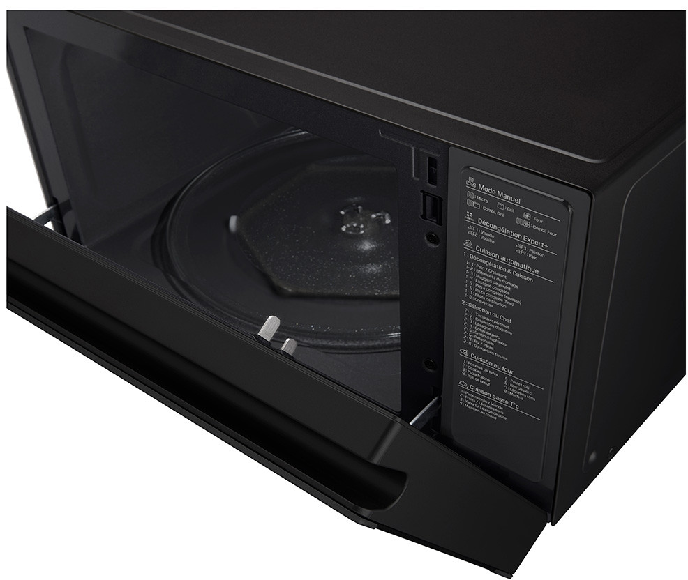 A black microwave oven with its door open. The interior is visible, including the turntable.